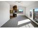 Bright living room with fireplace feature wall, large windows, and access to the deck at 7292 Firethorn, Littleton, CO 80125