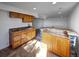Modern basement wet bar with granite countertops and wooden cabinets at 7292 Firethorn, Littleton, CO 80125