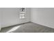 Bright bedroom with large window, plush carpet, and light walls at 10001 E Evans Ave # 58B, Aurora, CO 80247