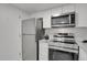 Updated kitchen showcasing stainless steel appliances and modern white cabinetry at 10001 E Evans Ave # 58B, Aurora, CO 80247