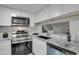 Updated kitchen features stainless steel appliances, granite countertops, and subway tile backsplash at 10001 E Evans Ave # 58B, Aurora, CO 80247