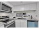 Modern kitchen featuring stainless steel appliances, white cabinets, and granite countertops at 10001 E Evans Ave # 58B, Aurora, CO 80247