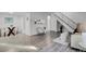 Open living area showcasing wood floors, modern decor, dining area and staircase at 10001 E Evans Ave # 58B, Aurora, CO 80247