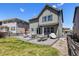 Spacious backyard patio featuring outdoor furniture and well-maintained lawn area at 1632 Saddlesmith Pl, Castle Pines, CO 80108