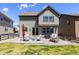 Backyard patio with outdoor seating, grill, and sliding glass door into the house at 1632 Saddlesmith Pl, Castle Pines, CO 80108