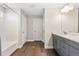 Clean bathroom featuring a shower over tub, gray vanity, and wood-look floors at 1632 Saddlesmith Pl, Castle Pines, CO 80108