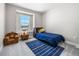 Cozy bedroom with plush carpeting, a window view, and a comfortable chair at 1632 Saddlesmith Pl, Castle Pines, CO 80108