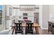 Open-concept kitchen and dining area with modern lighting at 1632 Saddlesmith Pl, Castle Pines, CO 80108