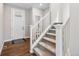 Bright entryway with wood floors and a carpeted staircase at 1632 Saddlesmith Pl, Castle Pines, CO 80108