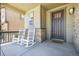 Inviting front porch with two rocking chairs offers a relaxing outdoor space at 1632 Saddlesmith Pl, Castle Pines, CO 80108