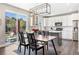 Well-appointed kitchen and dining area with stainless steel appliances and sliding glass doors to the back at 1632 Saddlesmith Pl, Castle Pines, CO 80108