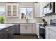 Modern kitchen featuring white cabinets, stainless steel appliances, and subway tile backsplash at 1632 Saddlesmith Pl, Castle Pines, CO 80108