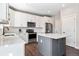 Modern kitchen with white cabinets, island, and stainless steel appliances at 1632 Saddlesmith Pl, Castle Pines, CO 80108