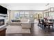 Spacious living room with a fireplace, hardwood floors, and plenty of natural light at 1632 Saddlesmith Pl, Castle Pines, CO 80108