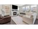 Cozy living room with a fireplace, large windows, and comfortable seating arrangement at 1632 Saddlesmith Pl, Castle Pines, CO 80108