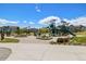 Community playground with modern play structures, seating areas, and manicured landscaping at 1632 Saddlesmith Pl, Castle Pines, CO 80108