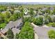 Aerial view of a home nestled in a lush neighborhood with mature trees and well-maintained landscaping at 5046 Sage Brush Dr, Broomfield, CO 80023