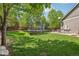 Spacious backyard featuring a trampoline and seating area, perfect for outdoor activities at 5046 Sage Brush Dr, Broomfield, CO 80023