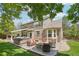 Resort-style backyard featuring a hot tub, outdoor kitchen, and a cozy seating area with a fire pit at 5046 Sage Brush Dr, Broomfield, CO 80023