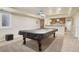 Finished basement with a billiard table and a wet bar at 5046 Sage Brush Dr, Broomfield, CO 80023