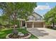 Charming two-story home with a three-car garage, mature landscaping, and a basketball hoop at 5046 Sage Brush Dr, Broomfield, CO 80023