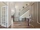 Welcoming foyer with wood floors, staircase, and view into the dining room at 5046 Sage Brush Dr, Broomfield, CO 80023