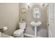 Cozy half bathroom with a pedestal sink, decorative mirror, and neutral wall color at 5046 Sage Brush Dr, Broomfield, CO 80023