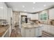 Bright kitchen with white cabinets, a center island, and stainless steel appliances at 5046 Sage Brush Dr, Broomfield, CO 80023