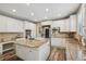Spacious kitchen with white cabinetry, stainless steel appliances, and a large island at 5046 Sage Brush Dr, Broomfield, CO 80023