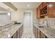 Elegant kitchenette features stainless steel sink, granite countertops, and custom wine rack at 5046 Sage Brush Dr, Broomfield, CO 80023