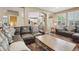 Open concept living room with hardwood floors, comfortable sofas, and view into the kitchen at 5046 Sage Brush Dr, Broomfield, CO 80023