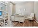 Bright home office with wood floors, large desk, and comfortable seating at 5046 Sage Brush Dr, Broomfield, CO 80023