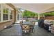 Relaxing covered patio featuring an outdoor dining area, hot tub, and grill perfect for entertaining at 5046 Sage Brush Dr, Broomfield, CO 80023