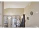 Open staircase with metal railing looking down to the living room at 5046 Sage Brush Dr, Broomfield, CO 80023