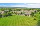 Aerial view of the community featuring a grassy park, sidewalks, and various home styles at 11268 Grove St # I, Westminster, CO 80031