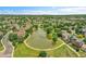Breathtaking aerial view of a community pond with a paved walking trail and lush green surroundings at 11268 Grove St # I, Westminster, CO 80031