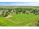Beautiful aerial shot of neighborhood park with large green area, volleyball and walking path at 11268 Grove St # I, Westminster, CO 80031