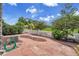 Landscaped backyard with stone patio and view of the surrounding green space at 11268 Grove St # I, Westminster, CO 80031