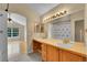 Well-lit bathroom featuring double sinks, a vanity, and an open doorway to the bedroom at 11268 Grove St # I, Westminster, CO 80031