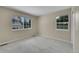 Cozy carpeted bedroom with two windows providing natural light and neighborhood views at 11268 Grove St # I, Westminster, CO 80031