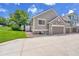 Exterior view of home with a two-car garage and stone accents at 11268 Grove St # I, Westminster, CO 80031