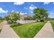 Well-manicured front yard features lush green grass and a charming white picket fence at 11268 Grove St # I, Westminster, CO 80031
