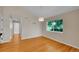 Inviting living room featuring hardwood floors and abundant natural light from a large window at 11268 Grove St # I, Westminster, CO 80031