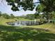 A scenic pond featuring a fountain and lush green surroundings offers a relaxing view at 11268 Grove St # I, Westminster, CO 80031