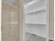 Clean and modern shower with an adjacent open walk-in closet at 11268 Grove St # I, Westminster, CO 80031