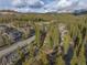An aerial view of a neighborhood surrounded by a lush forest and mountain range at 100 River Park Dr # A, Breckenridge, CO 80424