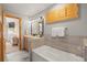 Bright bathroom featuring a tub, tiled shower, and wooden cabinets at 100 River Park Dr # A, Breckenridge, CO 80424