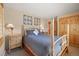 Comfortable bedroom with neutral tones and wood accents, along with a side table and lamp at 100 River Park Dr # A, Breckenridge, CO 80424