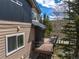 Outdoor deck with dining table and chairs with wooded and neighborhood views at 100 River Park Dr # A, Breckenridge, CO 80424