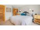 Comfortable bedroom with neutral tones, side tables, lamps, and wood trim throughout at 100 River Park Dr # A, Breckenridge, CO 80424
